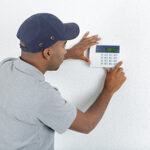 Ocean County air conditioner repair technician installing a programmable thermostat