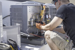 Ocean County air conditioner repair technician working on outdoor compressor